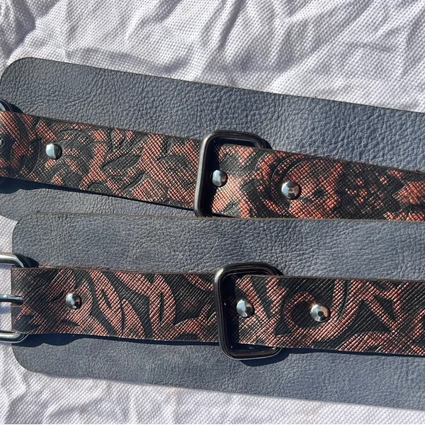 Bad Ass Bettie Casual Kink Cuffs. Set of 2. Blue soft cuff, black floral/metallic strap with black hardware